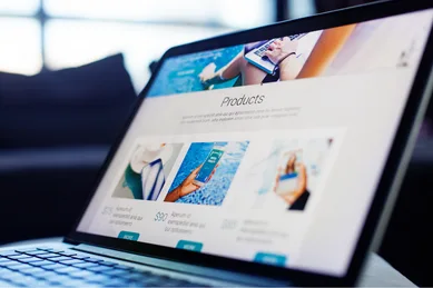 Laptop displaying a professionally designed website layout with product sections, representing conversion-focused web design and structured page development for service-based businesses.